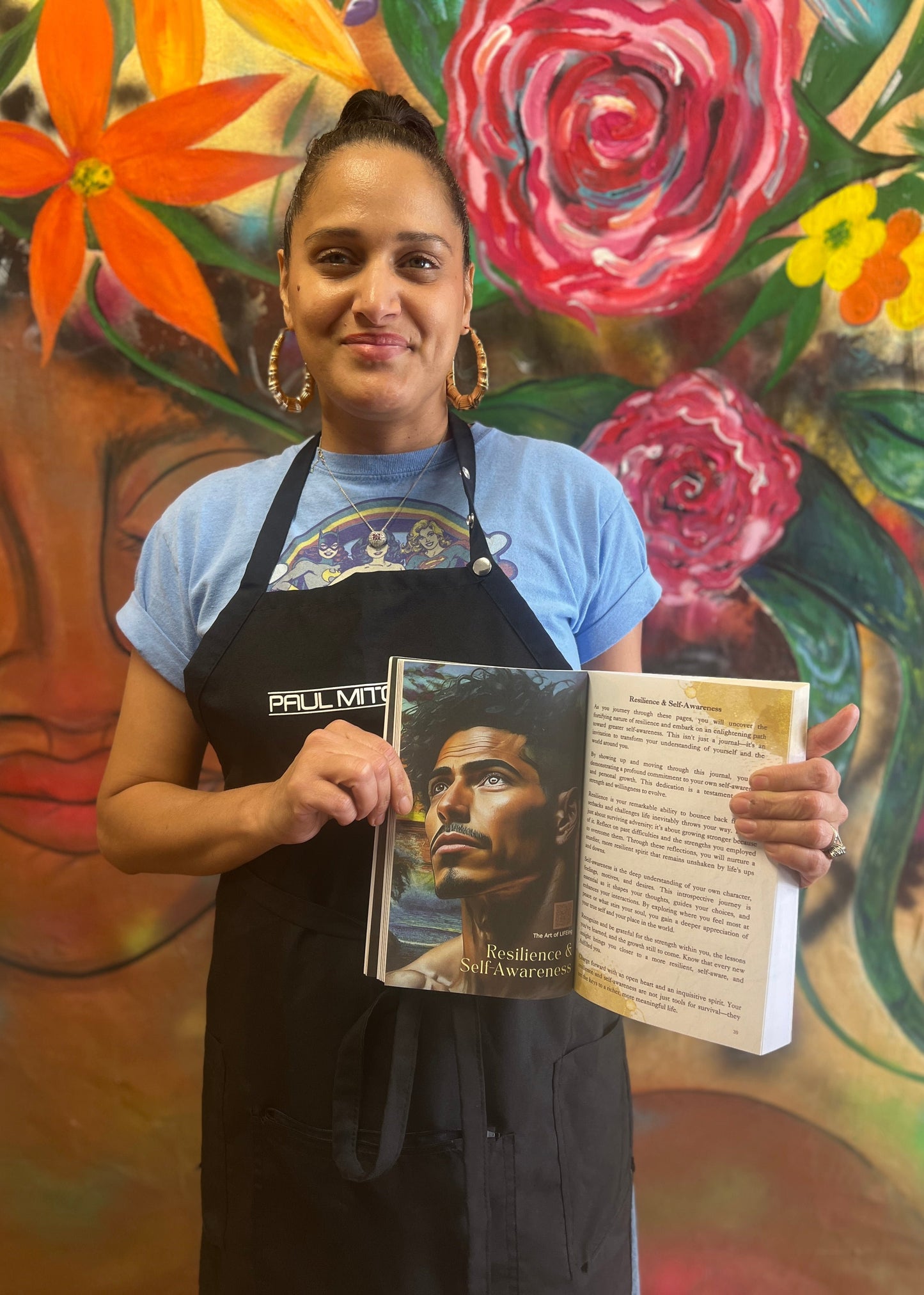 Hello Bonita Salon Baltimore owner Dina Tillman holding The Art of LIFEing Journal